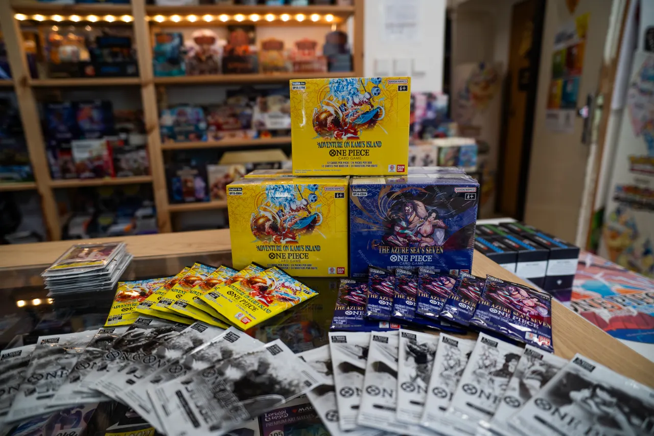 Tournament prizes — One Piece Card Game boxes and boosters on the shop counter
